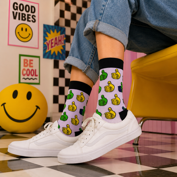 White crew socks with colorful thumbs up pattern in green, yellow, and blue.