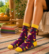 Purple crew socks with pineapple, cherry, watermelon, and citrus fruit patterns with yellow accents.