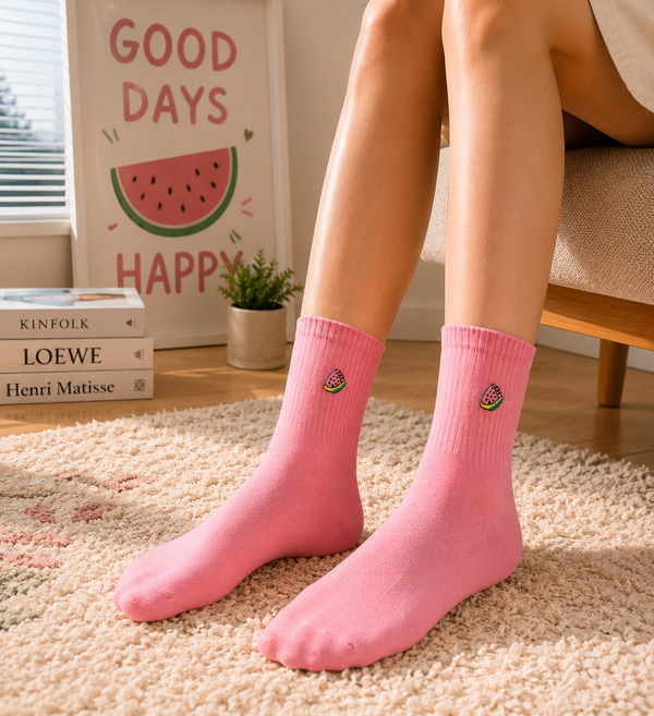 Pastel pink crew socks with small watermelon embroidery design.