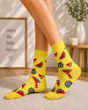 Yellow watermelon themed crew socks with colorful fruit slice pattern design