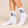 White crew socks with black When Nothing Goes Right Go Left slogan