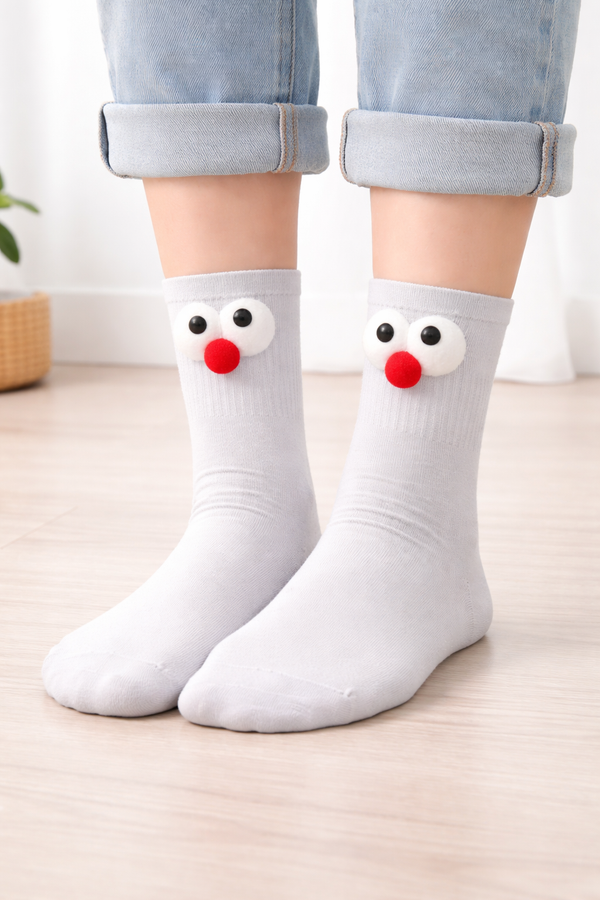 White crew socks with fluffy googly eye cartoon design for unisex casual wear