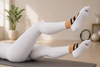 White pilates grip socks with black ballet straps and anti-slip heart grips