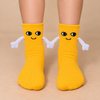 Yellow kids socks with cute smiling faces and magnetic connecting hands