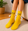 Yellow magnetic hug socks with smiling faces and magnetic plush hands
