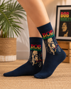 Black crew socks featuring Bob Marley portrait artwork with reggae inspired red yellow and green text design.